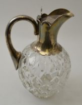 Goldsmiths & Silversmiths Co. A cut glass claret jug with silver mounts, Birmingham 1927