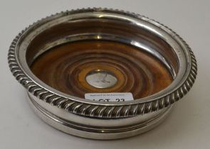 An early 19th century Sheffield plate coaster, to centre engraved greyhound crest, 15cm in diameter
