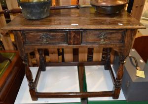 A part 17th century oak side table, fitted two drawers on baluster supports and plain cross stretche