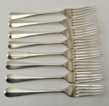 Eight silver Hanovarian pattern dessert forks, comprising a set of five by the Goldsmiths and Silver