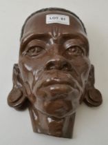 A glazed terracotta wall mounting mask, 25cm high
