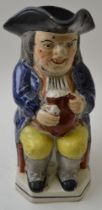 An early 19th century pottery "ordinary" Toby Jug, in the manner of Enoch Wood, holding a foaming ju