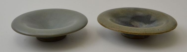 Two Chinese Sung Jun ware small shallow dishes on stepped bases, in celadon