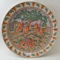 A Chinese ceramic charger, decorated with a European hunting scene, intended for the export market,