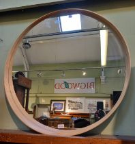 A modern large circular wood framed mirror