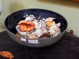 A highly decorative metal bowl of sea shells