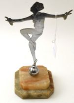 An Art Deco figure, chromed silhouette, etched with detail, standing upon a stepped alabaster base,