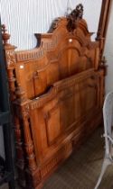 A possible walnut ornately carved a decorated double bed