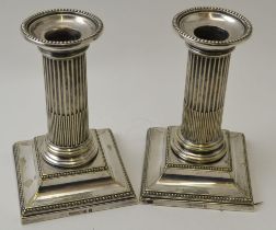 A pair of silver plated column candlesticks by Hawkesworth, Eyre & Co., 12.5cm high