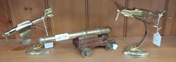 Brass model naval cannon and two brass model fighter planes