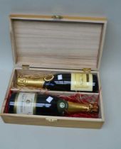 A wooden box containing two bottles of champagne - Nicolas Feuillatte and Marguet-Bonnerave