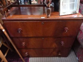 A three drawer mahogany chest of drawers