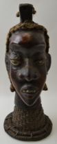 An African sculptural head, mixed media, including leather and straw raised upon a plaited cane neck