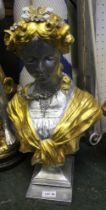 A plaster bust of a lady painted silver and gold