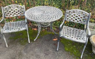 A grey painted metal garden table and two chairs