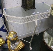 A wrought iron side table with glass top