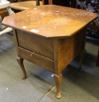 A vintage lift-top sewing box with contents