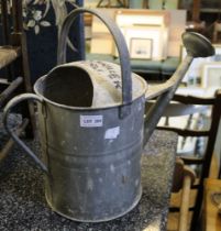 A galvanised metal watering can