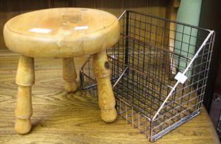 A small pine stool with a metal letter rack