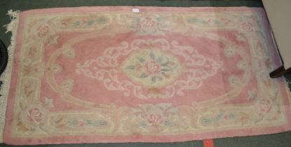 A Chinese washed woollen pink ground rug