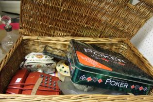 An F&M wicker hamper containing a selection of domestic items