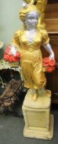 A garden statue of a lady on a plinth painted gold and silver