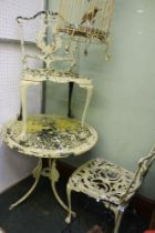 A well weathered metal garden bistro set, table and two chairs