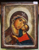 A 20th century hand painted icon of Mary and the infant Jesus on a wood panel