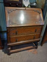 An Edwardian oak fall front bureau, green leather inset writing surface, fitted interior, over two d