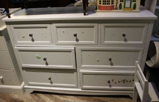 A white melamine three small over four larger drawers bedroom unit