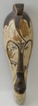 A carved wood African mask, elongated form, remains of partial painting, 32cm