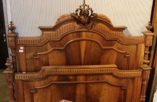 A possible walnut ornately carved & decorted double bed