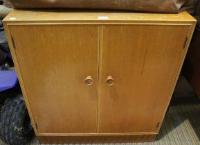Light oak two door cupboard containing two slide drawers