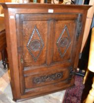 An 18th century oak hanging corner cupboard, carved decoration, 97cm high