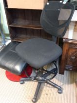 A high swivel office chair together with a leather upholstered foot stool