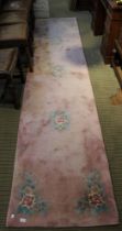 A pink ground floral decorated hall runner, 365cm approx