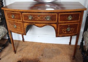 A 19th century satinwood bow fronted sideboard of Sheraton design, fitted drawers, marquetry inlaid