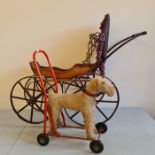 A pedigree push along dog and a toy wood and metal pram.