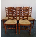 A good quality distressed oak reproduction oval gateleg table with a matching set of eight ladder