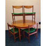 A set of four GPlan teak dining chairs together with a teak dining table and sideboard.