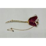 A ruby and diamond rose brooch, the rosebud petals mystery set with calibre cut rubies and round