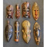 Eight carved wood African tribal masks.