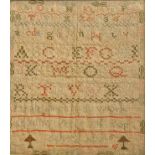 A framed and glazed 19th century sampler dated 1815. 29 1/2 cm 34 1/2 cm.