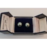 A pair of black pearl stud earrings each pearl measuring approx 10mm stamped 750