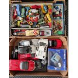 Two boxes of model diecast cars and trucks.