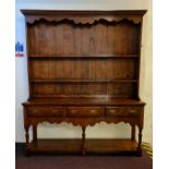 A good quality distressed oak reproduction kitchen dresser fitted with three drawers to base and