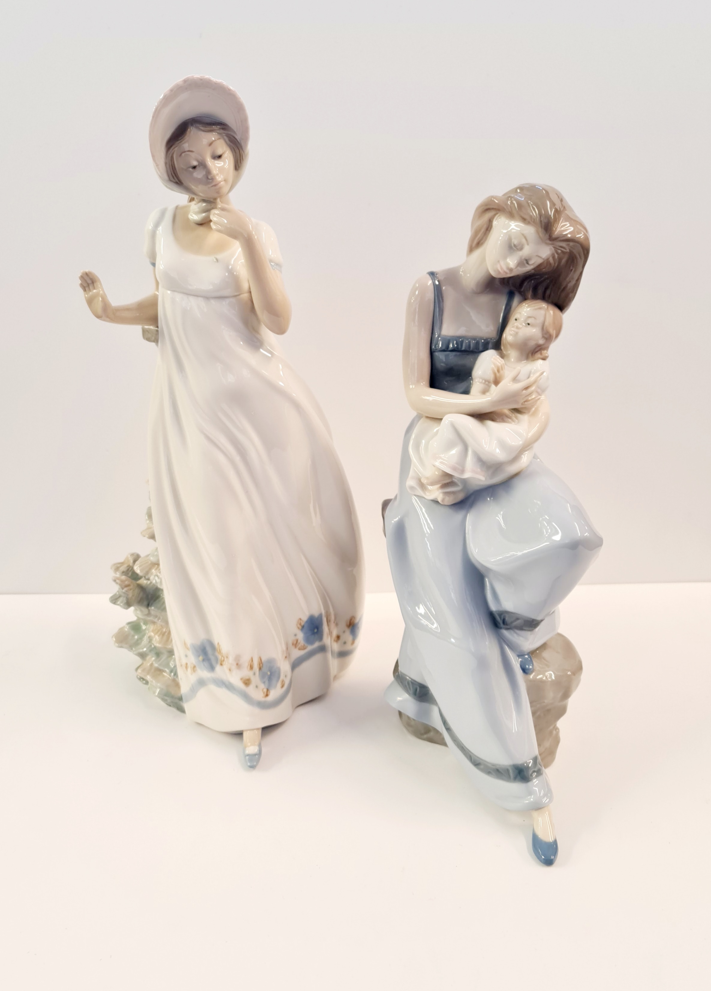 Two large Nao figures Mother and child and lady with bonnet.