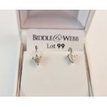 A pair of hallmarked 18ct white gold diamond earrings, each set with a triangular cut diamond,