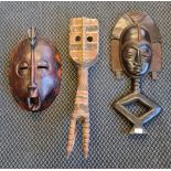 Three carved wood African tribal masks.