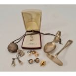 A pearl style pendant on chain with various clip and screw on stud earrings, an oval decorative